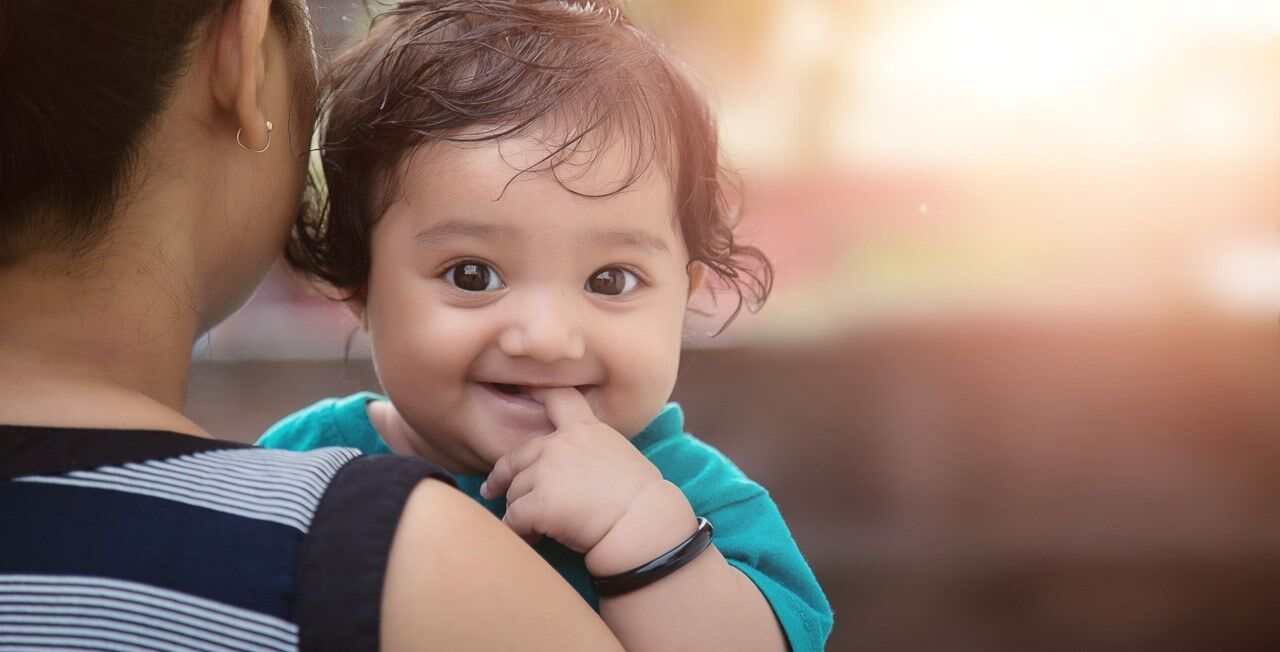 Woman holding a smiling baby