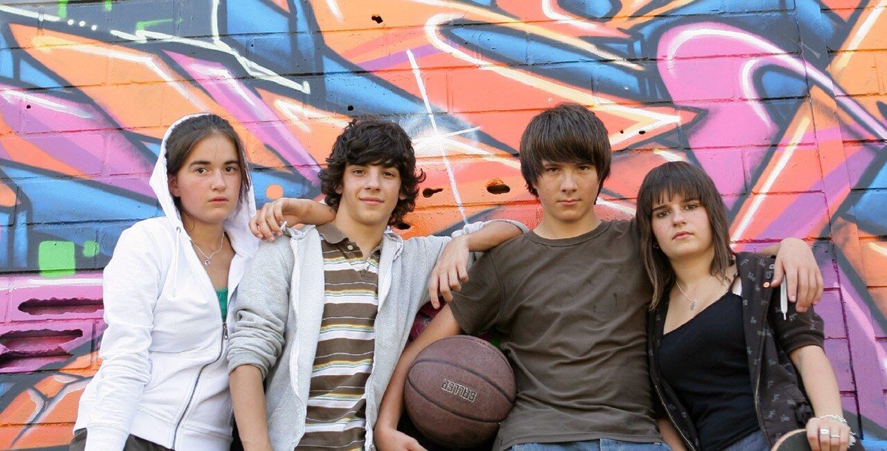 Group of youth with skateboards and basketball