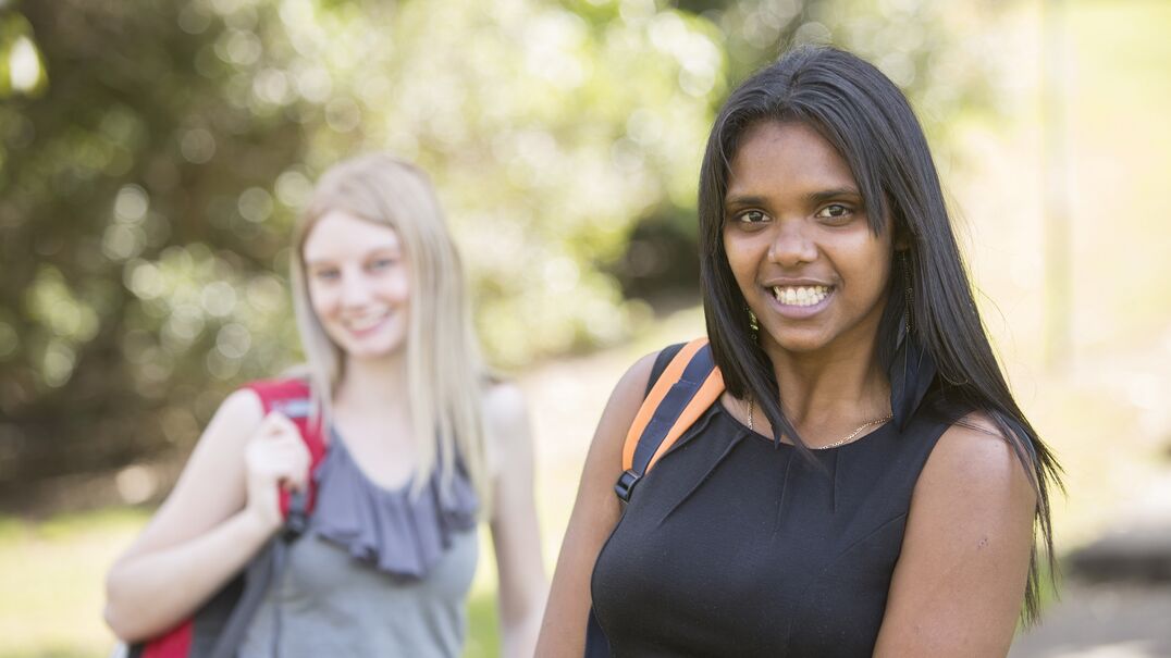 Two female adolescents smiling